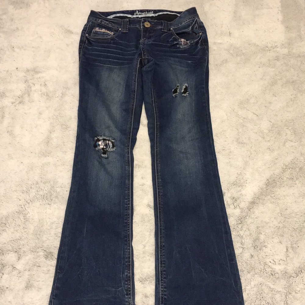 Dark wash blue bootcut jeans with patches
